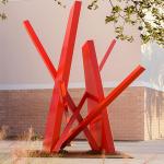 Large red steel beam outdoor sculpture.