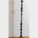 Iron sculpture that looks like a staff.